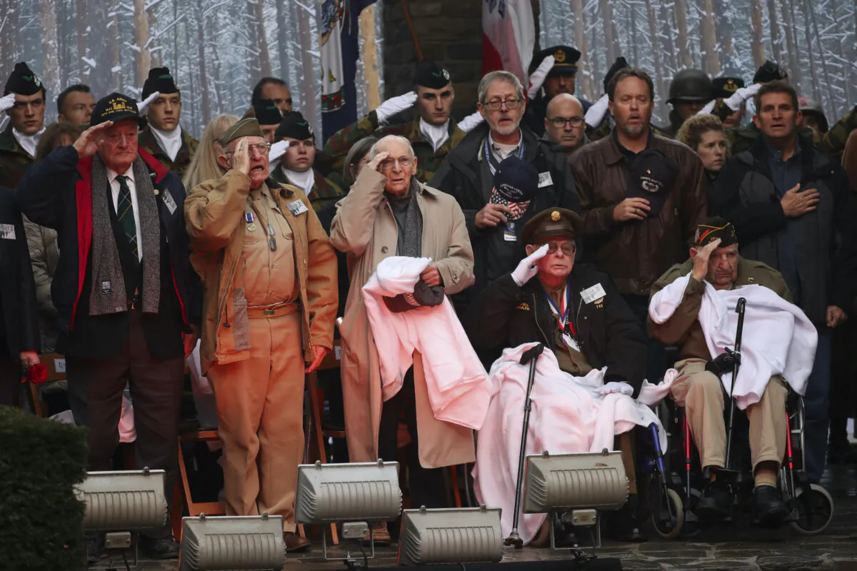 U.S. Battle of the Bulge veterans, front row, listen to the U.S. national anthem during a ceremony to commemorate the 75th anniversary of the Battle of the Bulge at the Mardasson Memorial in Bastogne, Belgium, on Monday, Dec. 16, 2019. (Francisco Seco/AP)