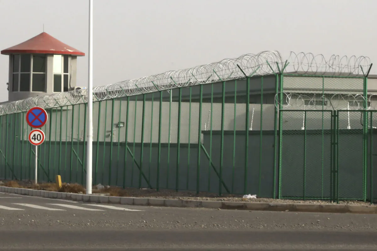 A guard tower and barbed wire fences are seen around a facility in the Kunshan Industrial Park in Artux in western China's Xinjiang region on Dec. 3, 2018. People in touch with state employees in China say the government in the far west region of Xinjiang is destroying documents and taking other steps to tighten control on information. (Ng Han Guan/AP Photo)