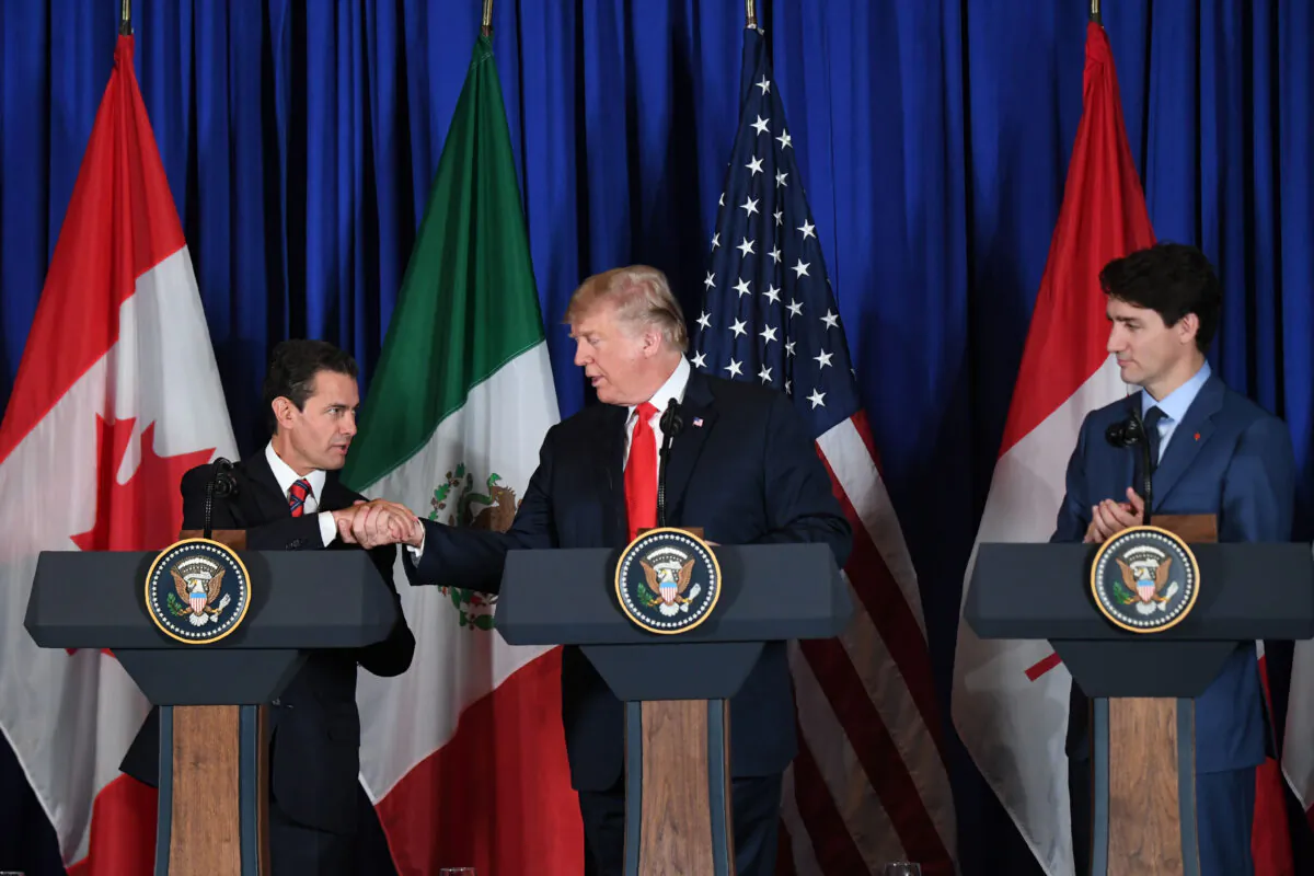 (L to R) Mexican President Enrique Pena Nieto, U.S. President Donald Trump, and Canadian Prime Minister Justin Trudeau deliver a statement on the signing of a new free trade agreement in Buenos Aires, on the sidelines of the G20 Leaders' Summit, on Nov. 30, 2018. (MARTIN BERNETTI/AFP via Getty Images)