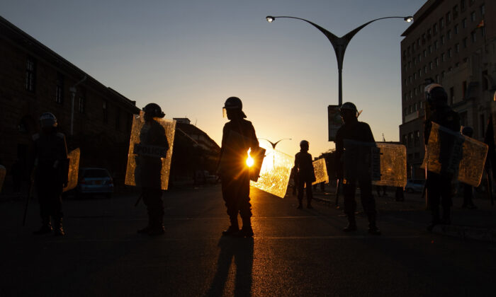 Anti-riot police block the entrance to the Magistrates court in Bulawayo, Zimbabwe, on Aug. 19, 2019. Nearly two years after President Emmerson Mnangagwa took power, the country faces rising inflation, increased poverty, and a severe water shortage. (Tafadzwa Ufumeli/Getty Images)