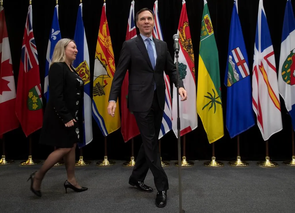 Minister of Finance Bill Morneau and Associate Minister of Finance Minister Mona Fortier step up to the microphone to speak with the media before attending a meeting of federal and provincial finance ministers on Dec. 17, 2019 in Ottawa. (The Canadian Press/Adrian Wyld)