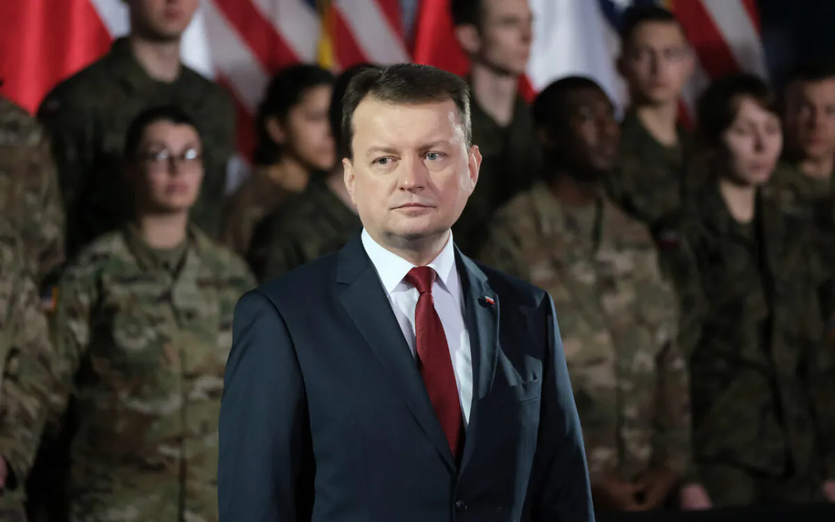 Mariusz Blaszczak, National Defense Minister of Poland, stands near U.S. soldiers during the visit of U.S. Vice President Mike Pence at a military base on February 13, 2019 in Warsaw, Poland. ( Sean Gallup/Getty Images)