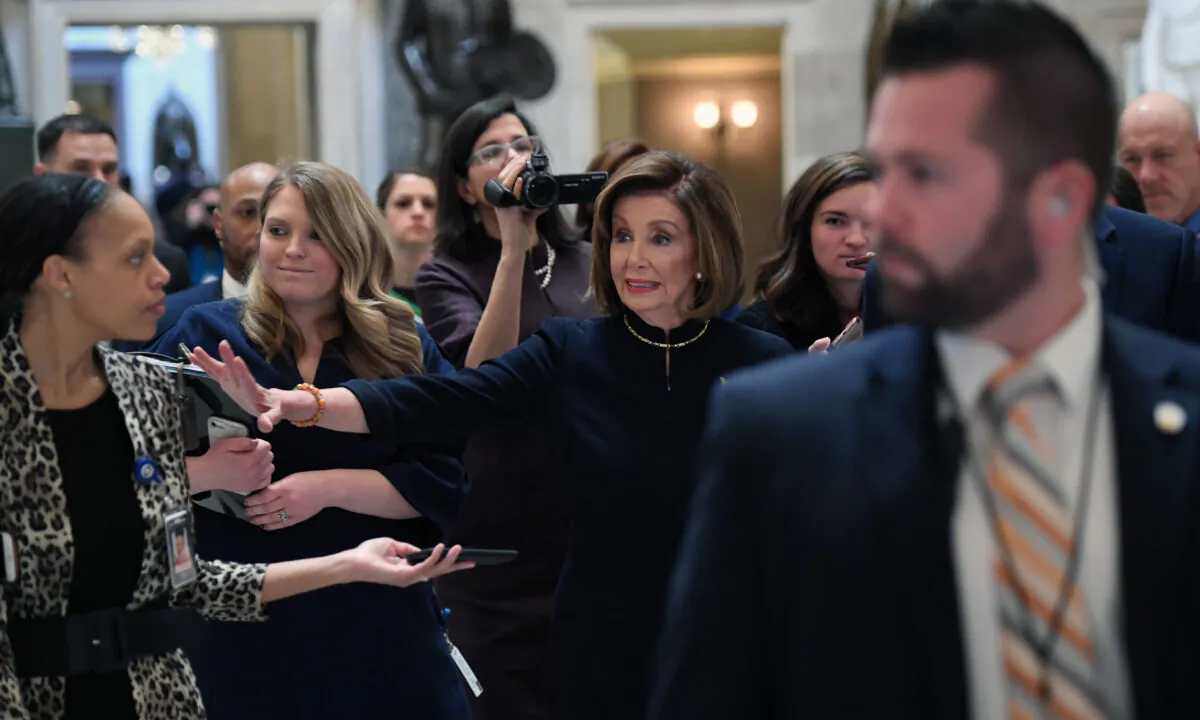 House Speaker Nancy Pelosi (D-Calif.) walks to the House floor at the US Capitol, while the House readies for a historic vote on December 18, 2019. (SAUL LOEB/AFP via Getty Images)