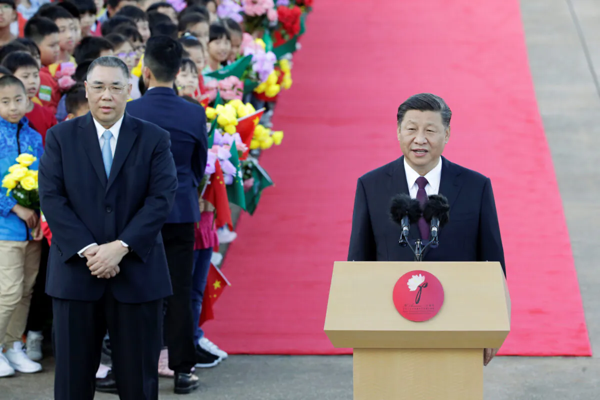 Chinese leader Xi Jinping speaks next to outgoing Macau Chief Executive Fernando Chui at Macau International Airport in Macau, China on Dec. 18, 2019, ahead of the 20th anniversary of the former Portuguese colony's return to China. (Jason Lee/Reuters)