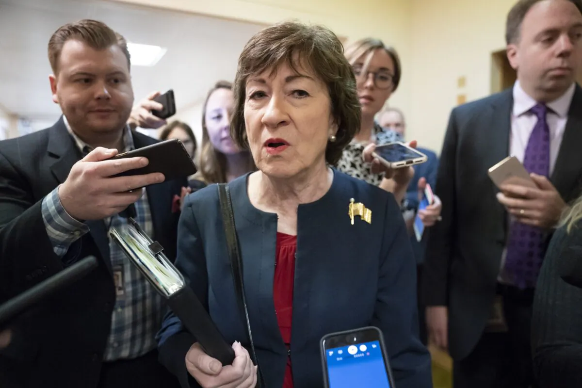 Sen. Susan Collins (R-Maine) is surrounded by reporters as she heads to vote at the Capitol in Washington on Nov. 6, 2019. (J. Scott Applewhite/AP Photo)