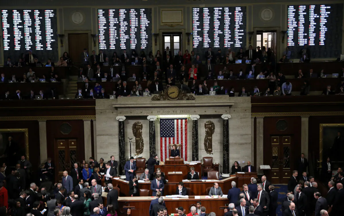 A tote board shows the votes of members of Congress as U.S. Speaker of the House Nancy Pelosi (D-Calif.) presides over the final of two House of Representatives votes approving two counts of impeachment against President Donald Trump in the House Chamber of the U.S. Capitol in Washington, on Dec. 18, 2019. (Jonathan Ernst/Reuters)