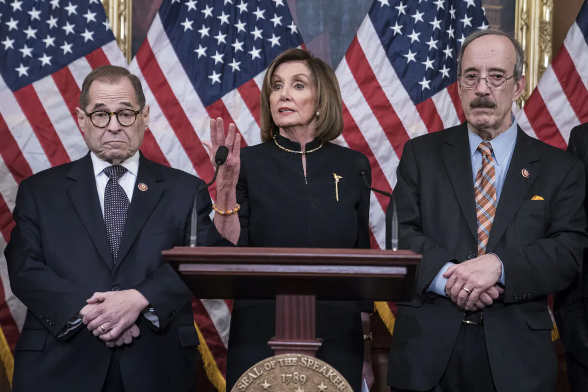 House Speaker Nancy Pelosi (D-Calif.) delivers remarks alongside House Judiciary Chairman Jerry Nadler (D-N.Y.) and House Foreign Affairs Chairman Eliot Engel (D-N.Y.) following the House of Representatives vote to impeach President Donald Trump in Washington on Dec. 18, 2019. (Sarah Silbiger/Getty Images)