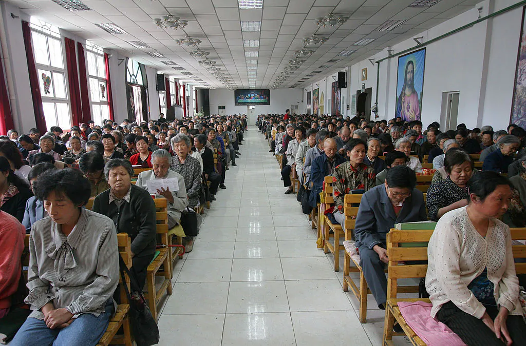 Christians pray during a mass at a church in Xining in China's northwest Qinghai Province, on July 3, 2005. China officially sanctions five religious groups: Protestantism, Catholicism, Islam, Buddhism and Taoism. The Chinese are allowed to worship only in state-sanctioned churches and temples. (China Photos/Getty Images)