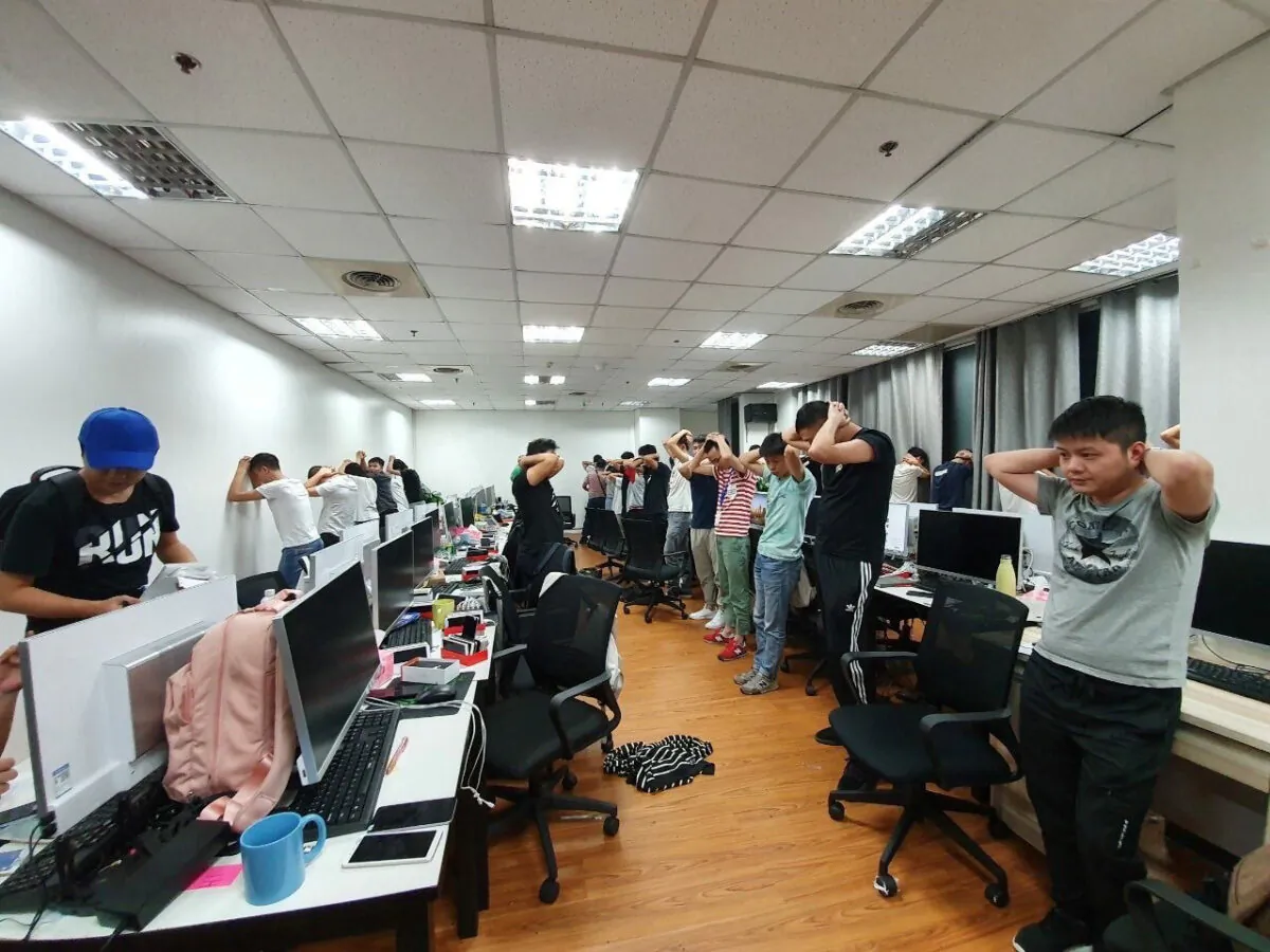 Chinese workers illegally working at an unlicensed online gambling firm are arrested by Philippine authorities at an office building in Quezon City, Metro Manila, Philippines on Dec. 19, 2019. (Bureau of Immigrations/Handout via Reuters)