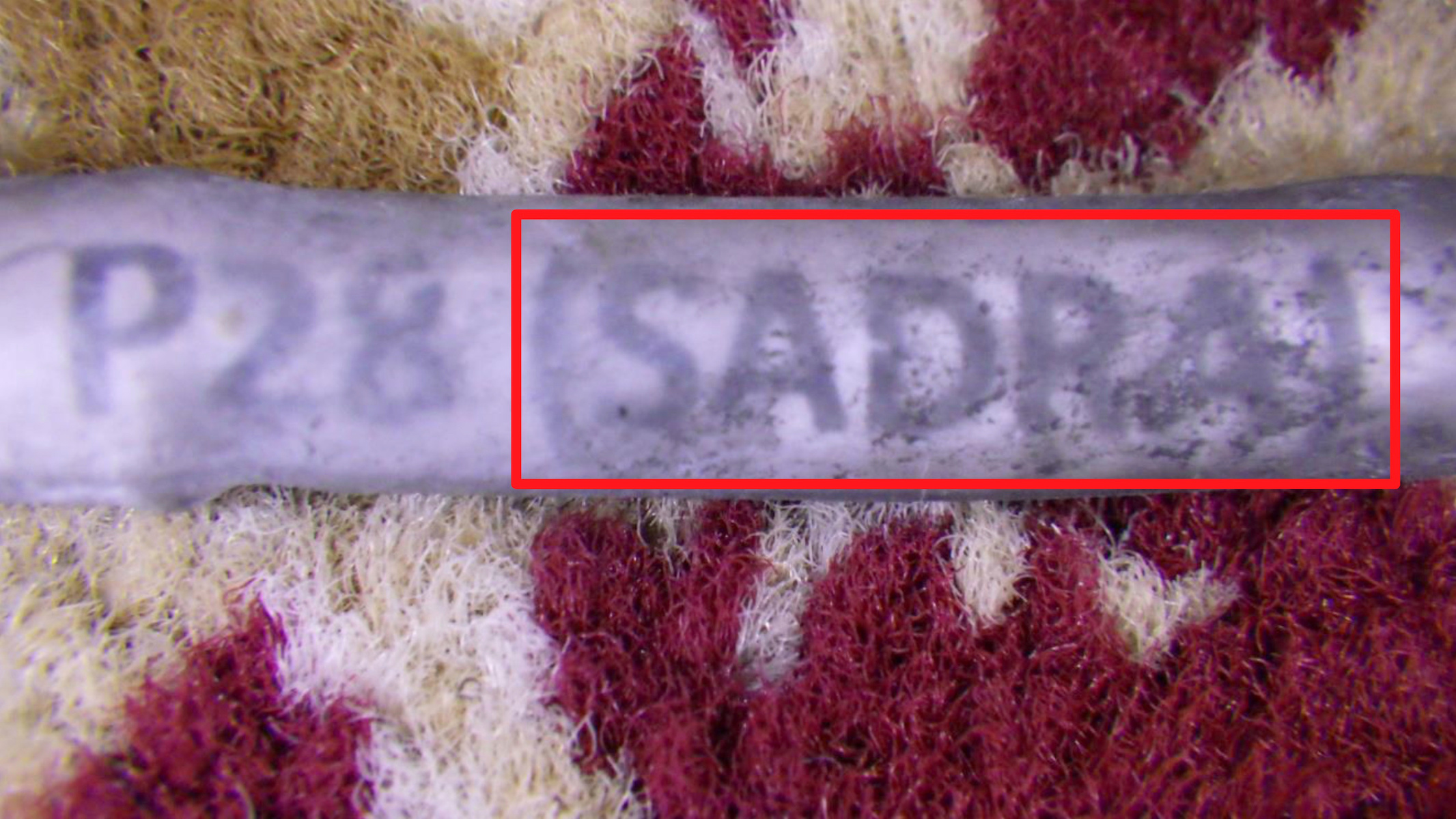 The name of a company believed by U.S. government authorities to be associated with Iran, SADRA, is seen on a wiring harness label from the wreckage