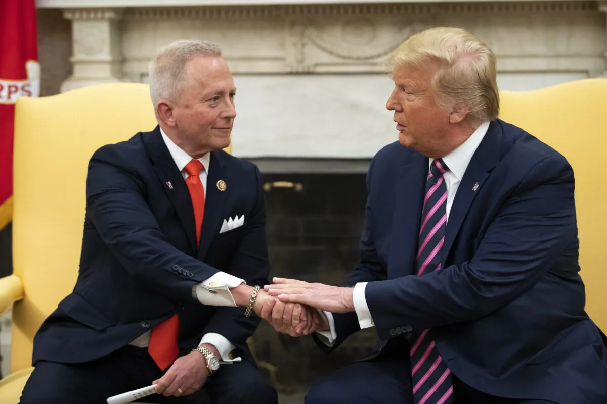 Rep. Jeff Van Drew (R-N.J.) meets with President Donald Trump in the Oval Office of the White House in Washington on Dec. 19, 2019. (Drew Angerer/Getty Images)