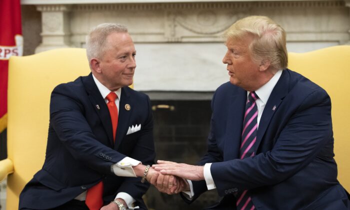 Rep. Jeff Van Drew (R-N.J.), left, meets with President Donald Trump in the Oval Office of the White House in Washington on Dec. 19, 2019. Van Drew left the Democrat Party for the GOP over the former's shift away from moderates. (Drew Angerer/Getty Images)
