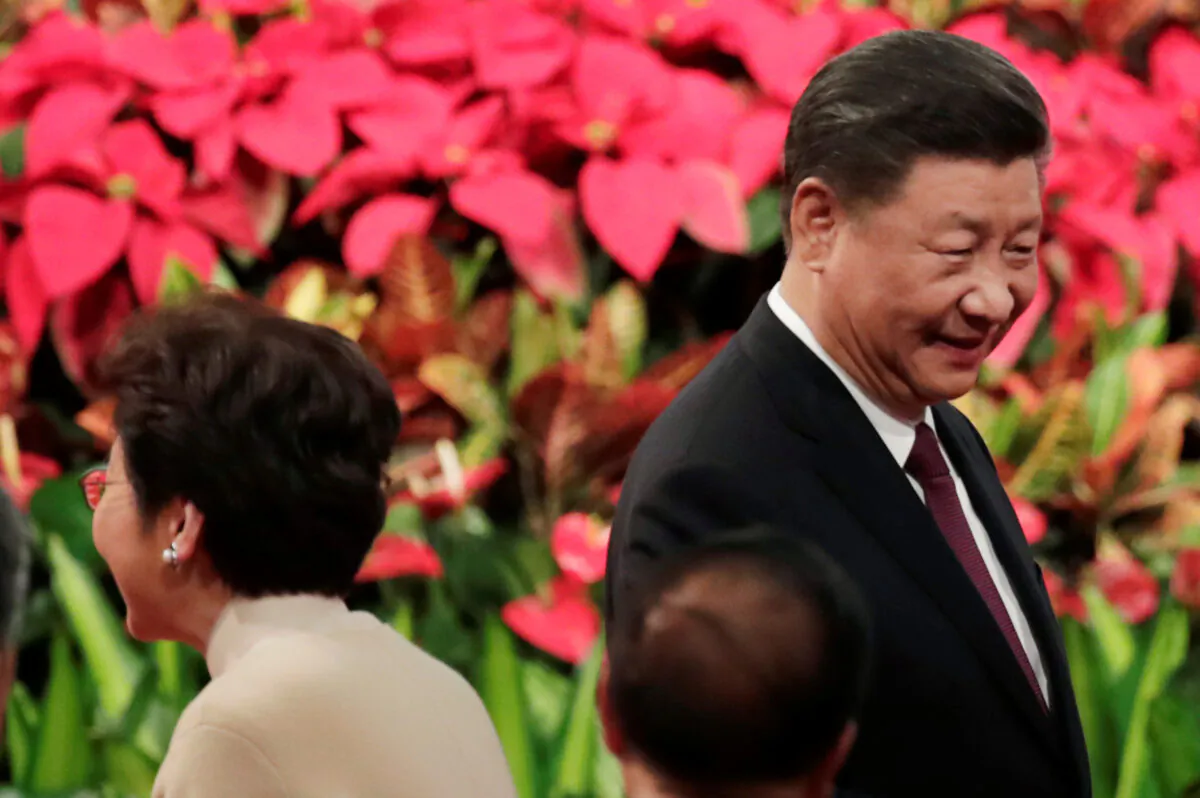 Chinese President Xi Jinping and Hong Kong Chief Executive Carrie Lam attend a ceremony to celebrate the 20th anniversary of the former Portuguese colony's return to Chinese rule, in Macau, China, on Dec. 20, 2019. (Jason Lee/Reuters)