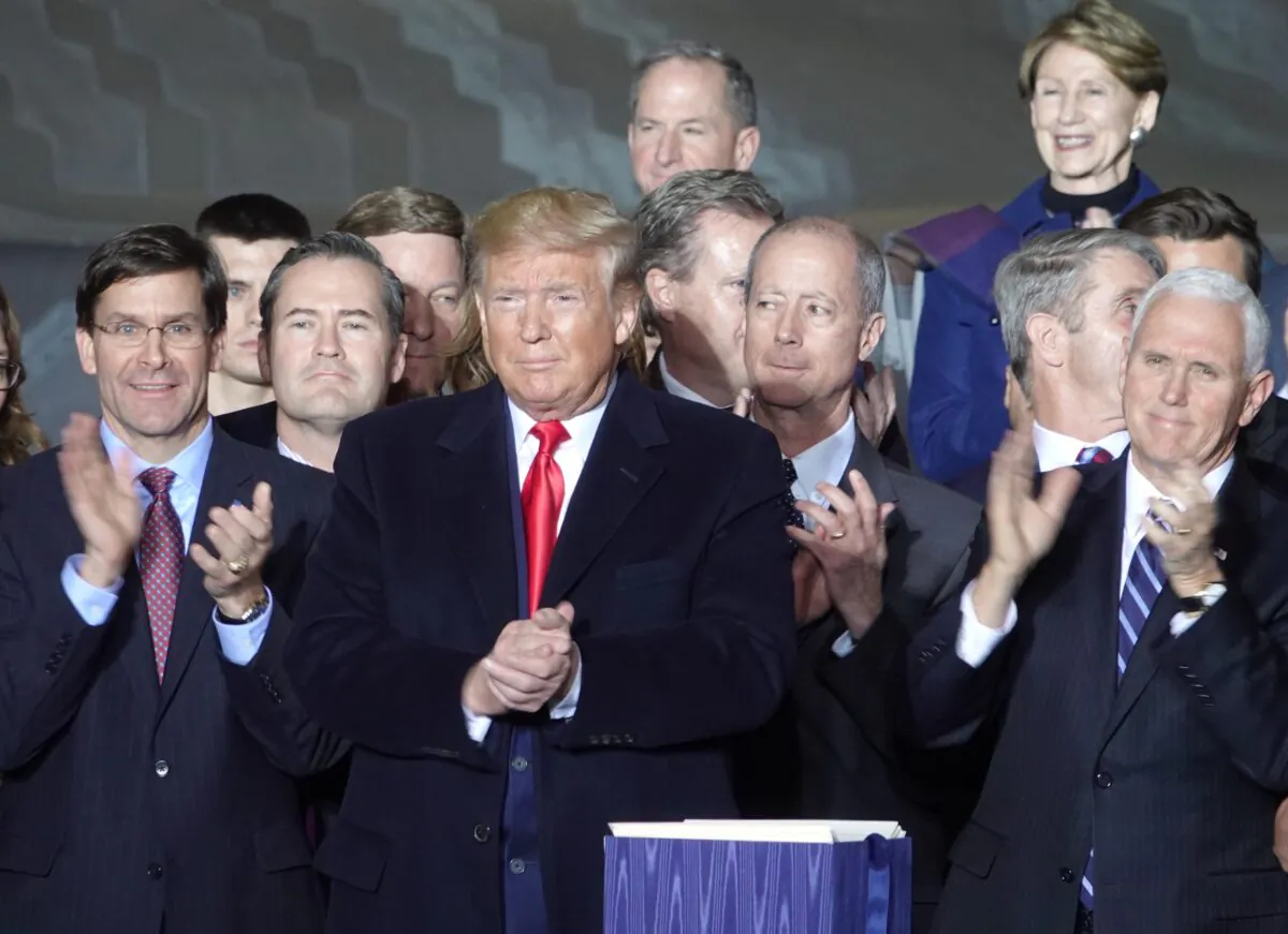 President Donald Trump signs the National Defense Authorization Act (NDAA) at Joint Base Andrews in Maryland, on Dec. 20, 2019. (Jenny Jing/Epoch Times)