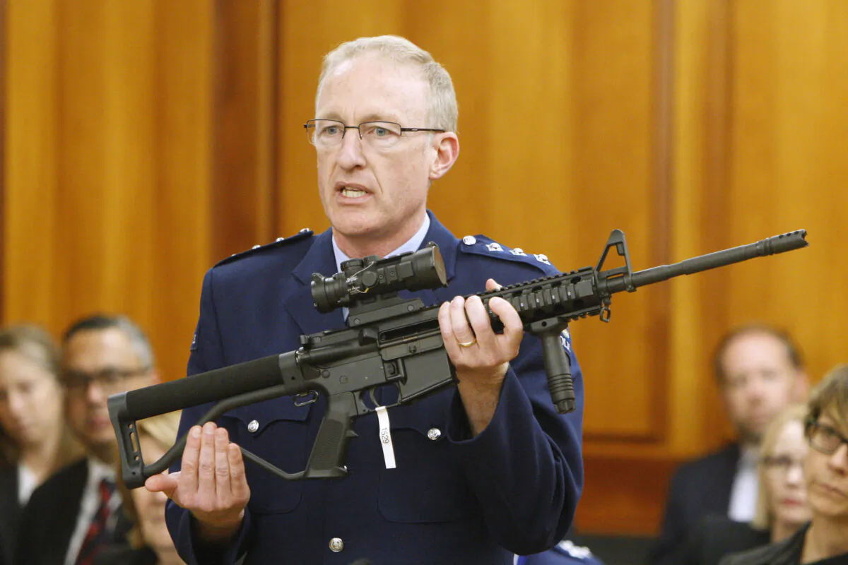 New Zealand's Police acting superintendent Mike McIlraith shows New Zealand lawmakers an AR-15 style rifle similar to one of the weapons a gunman used to slaughter 51 people at two mosques, in Wellington, New Zealand, on April 2, 2019. (AP Photo/Nick Perry, File)