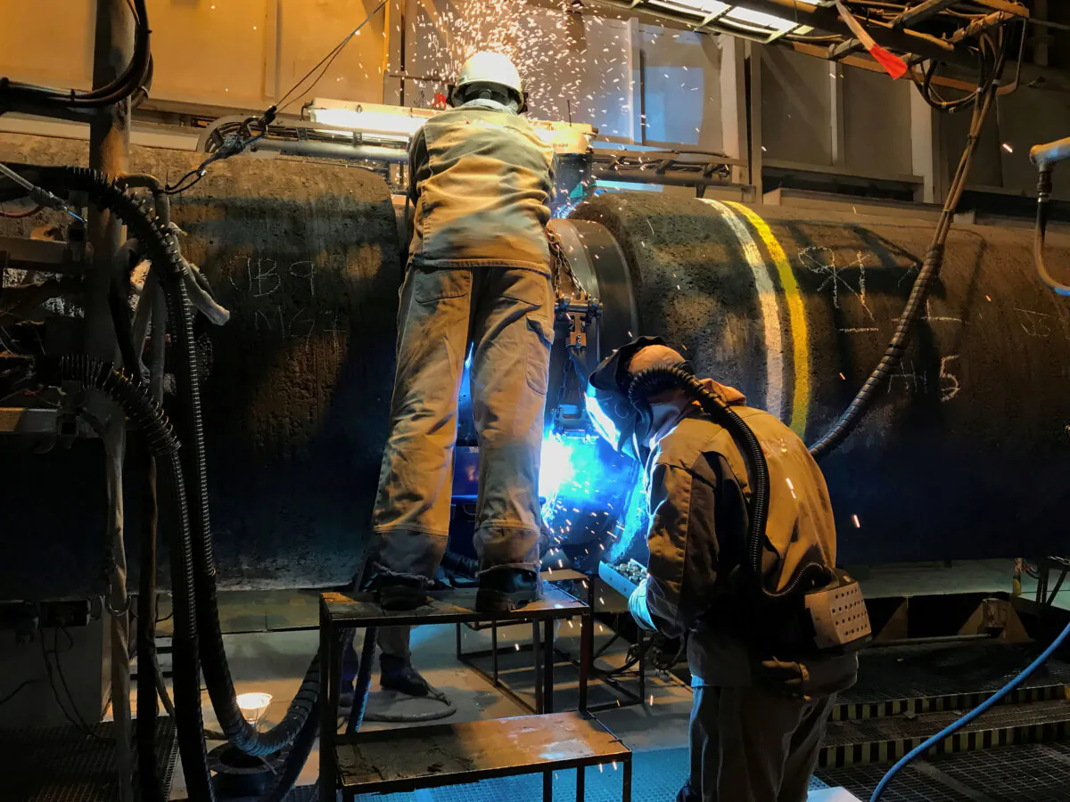 Specialists work onboard Allseas's deep sea pipe laying ship Solitaire to prepare pipe for Nord Stream 2 pipeline in the Baltic Sea on Sept. 13, 2019. (Stine Jacobsen/Reuters)