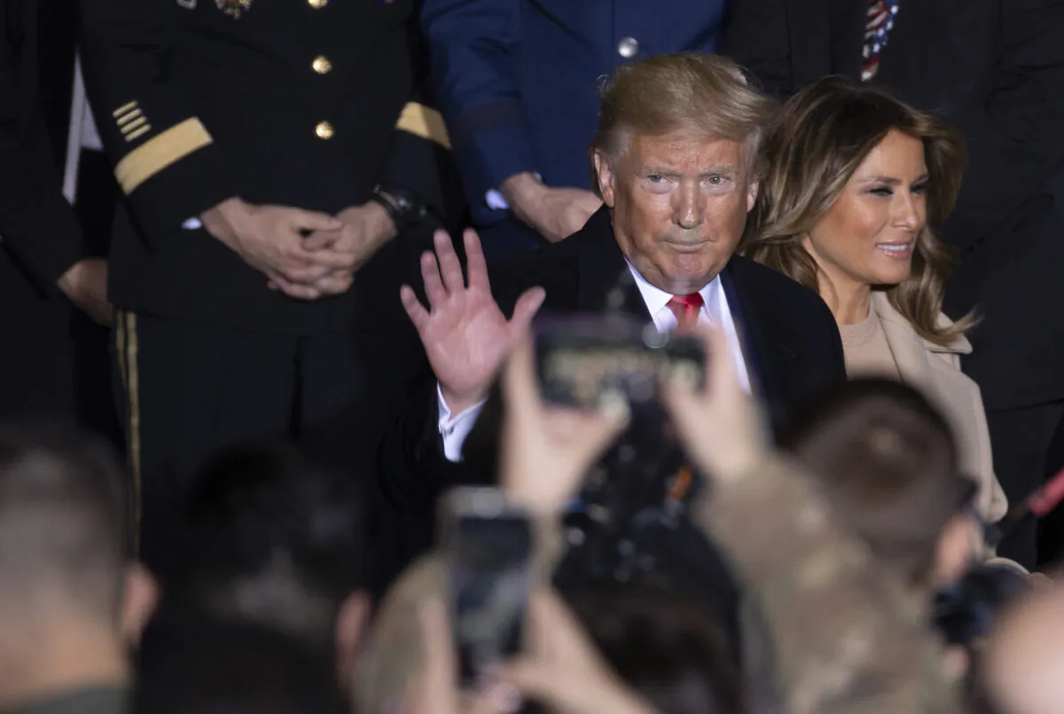 President Donald Trump and First Lady Melania Trump greet troops at the signing ceremony for S.1709, The National Defense Authorization Act for Fiscal Year 2020 in Joint Base Andrews, Maryland on Dec.  20, 2019. (Tasos Katopodis/Getty Images)