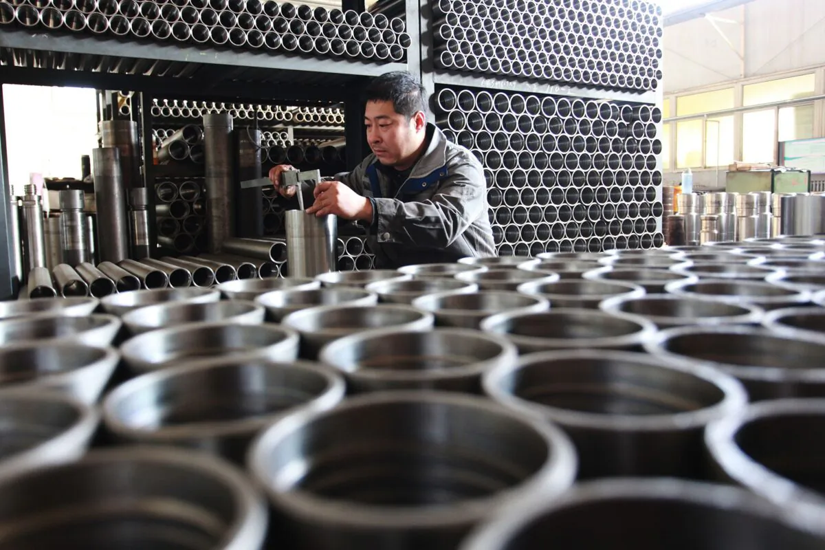 A worker is checking drilling tool components at a factory in Xuanhua city in China's northern Hebei province on December 18, 2019. (STR/AFP via Getty Images)