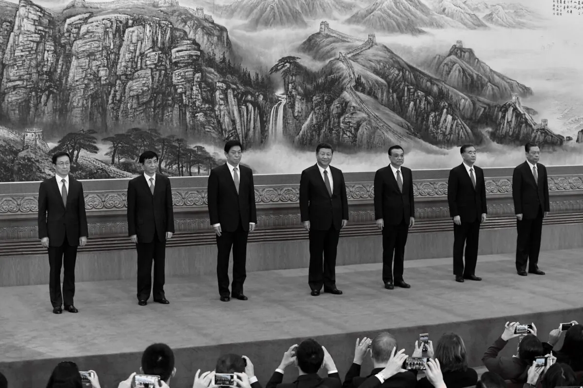 The Chinese Communist Party's Politburo Standing Committee, the nation's top decision-making body (L-R): Han Zheng, Wang Huning, Li Zhanshu, Chinese leader Xi Jinping, Premier Li Keqiang, Wang Yang, and Zhao Leji meet the press at the Great Hall of the People in Beijing on Oct. 25, 2017. (Wang Zhao/AFP via Getty Images)