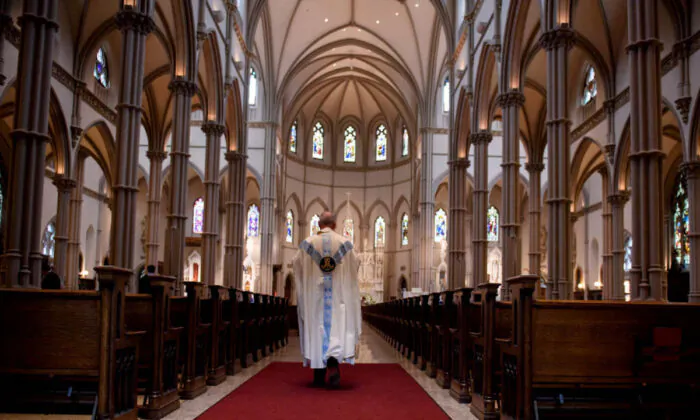 A priest walks to the sanctuary following a mass in Pittsburgh, Pa., on Aug. 15, 2018. (Jeff Swensen/Getty Images)