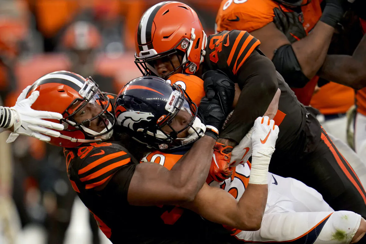 Denver Broncos running back Phillip Lindsay, center, is tackled by Cleveland Browns defensive tackle Sheldon Richardson, left, during the second half of NFL football game in Denver on Nov. 3, 2019. (Jack Dempsey/AP-File)