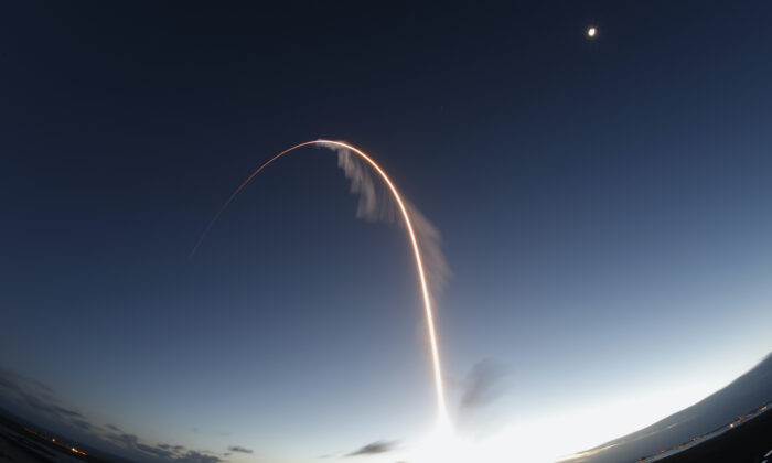 In this long exposure photo, the United Launch Alliance Atlas V rocket carrying the Boeing Starliner crew capsule lifts off on an orbital flight test to the International Space Station from Space Launch Complex 41 at Cape Canaveral Air Force station, in Cape Canaveral, Fla., on Dec. 20, 2019. (Terry Renna/AP)