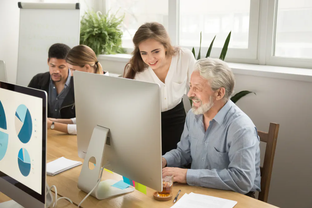 Young workers should work to form relationships with older colleagues or even engage in "reverse mentorships," helping an older worker learn a new technology skill. (Shutterstock)