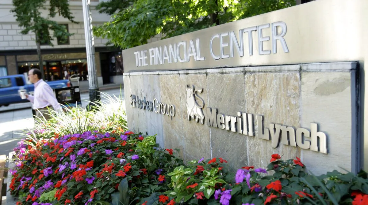 A pedestrian walks past a sign for a Merrill Lynch office in downtown Seattle on Sept. 15, 2008. (Ted S. Warren/AP Photo)