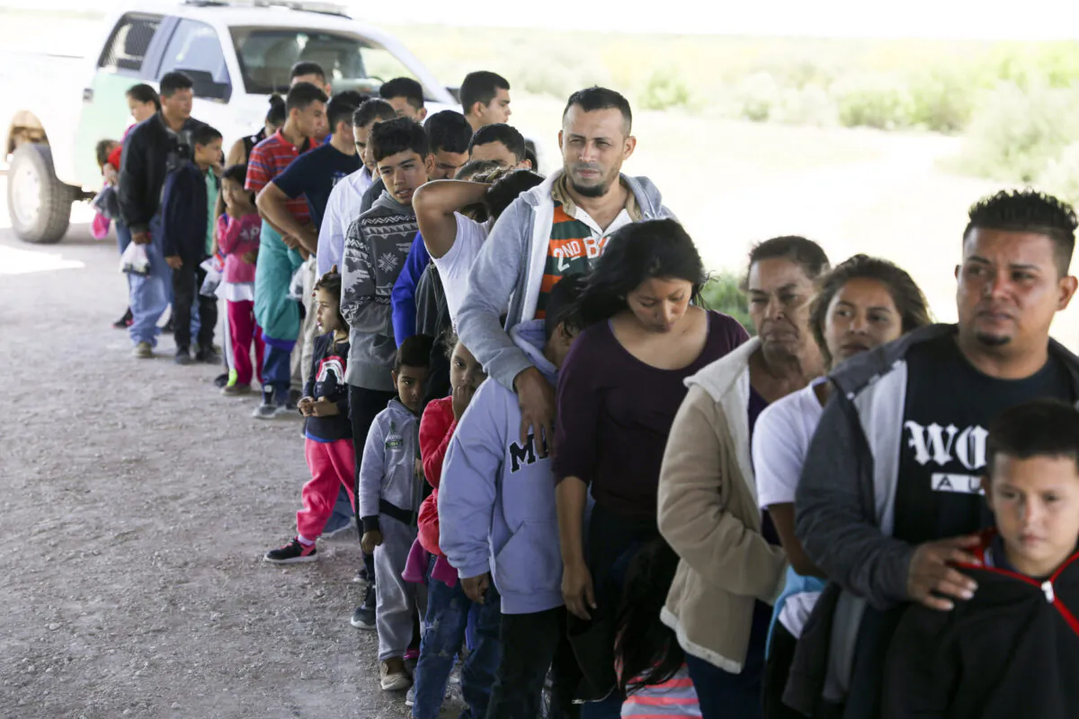 Illegal aliens who have been apprehended after crossing the Rio Grande from Mexico near McAllen, Texas, on April 18, 2019. (Charlotte Cuthbertson/The Epoch Times)
