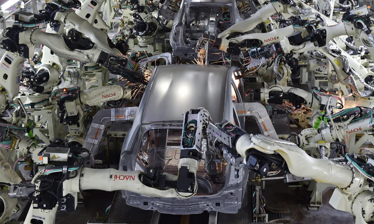 A welding workshop uses automated welding machine robots that assemble automobile bodies at Toyota Motor's Tsutsumi plant in Toyota, Aichi prefecture, on Dec. 4, 2014. The supposed goal behind universal basic income is to help displaced workers who can’t keep up with labor market developments, like automation and immigration, or otherwise disenfranchised people.  Kazuhiro Nogi/AFP via Getty Images