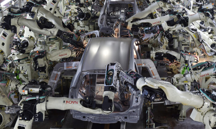 A welding workshop uses automated welding machine robots that assemble automobile bodies at Toyota Motor's Tsutsumi plant in Toyota, Aichi prefecture, on Dec. 4, 2014. The supposed goal behind universal basic income is to help displaced workers who can’t keep up with labor market developments, like automation and immigration, or otherwise disenfranchised people.  Kazuhiro Nogi/AFP via Getty Images