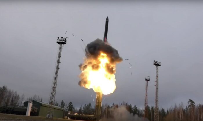 An intercontinental ballistic missile lifts off from a truck-mounted launcher somewhere in Russia. (Russian Defense Ministry Press Service via AP)
