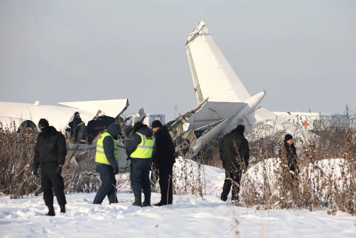 Emergency and security personnel are seen at the site of a plane crash near Almaty, Kazakhstan, on Dec. 27, 2019. (Pavel Mikheyev/Reuters)