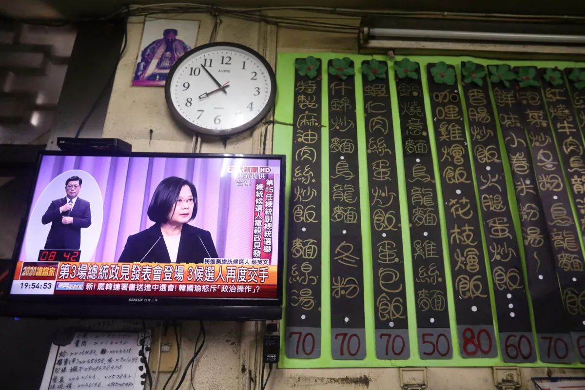 Taiwan President Tsai Ing-wen is seen on a TV screen during the third live policy address ahead of January's election, in Tainan, Taiwan, on Dec. 27, 2019. (Ann Wang/Reuters)
