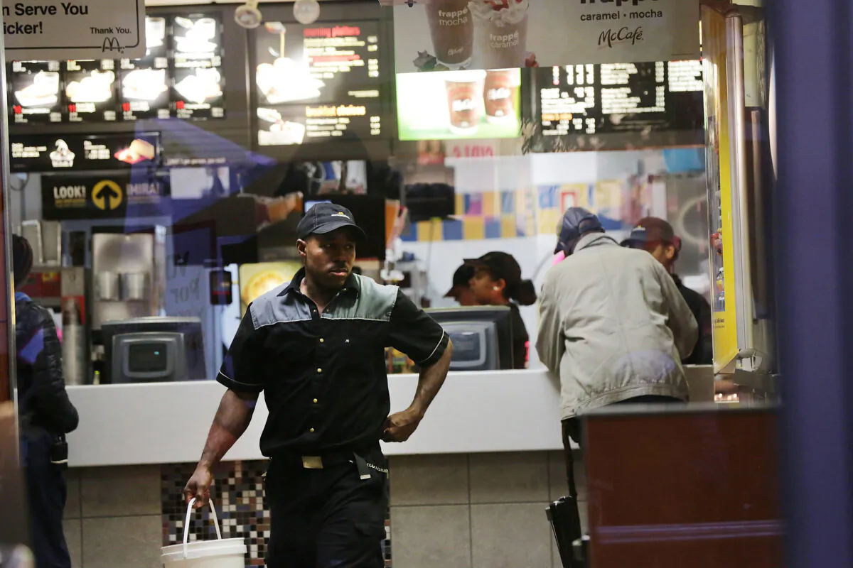 A McDonald's worker walks in a restaurant in New York on Nov. 10, 2015. (Spencer Platt/Getty Images)