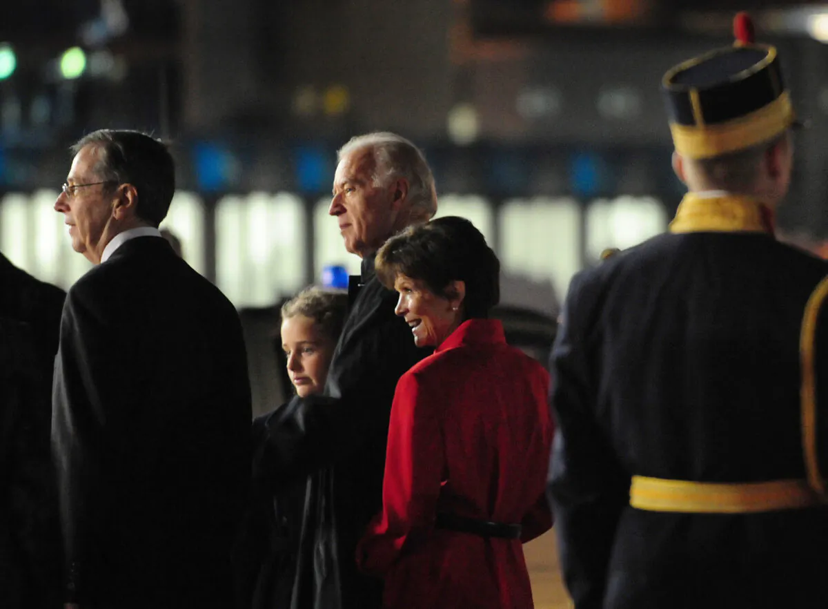 (L–R) Mark Gitenstein, former U.S. ambassador to Romania; Finnegan James Biden, granddaughter of former Vice President Joe Biden; Joe Biden; and Libby Gitenstein, wife of Mark Gitenstein arrive at the Henry Coanda International Airport in Bucharest on Oct. 21, 2009. (Daniel Mihailescu/AFP via Getty Images)