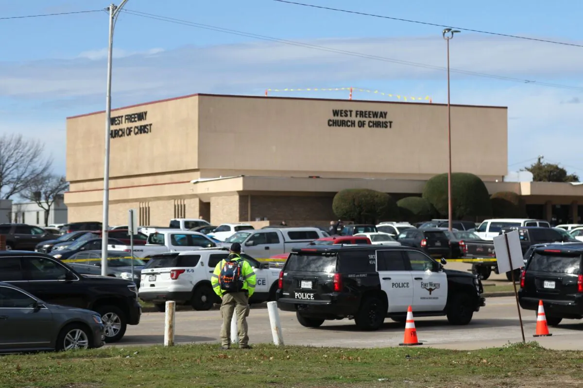 A person stands near the scene of a church shooting at West Freeway Church of Christ in White Settlement, Texas, on Dec. 29, 2019. (Juan Figueroa/The Dallas Morning News via AP)
