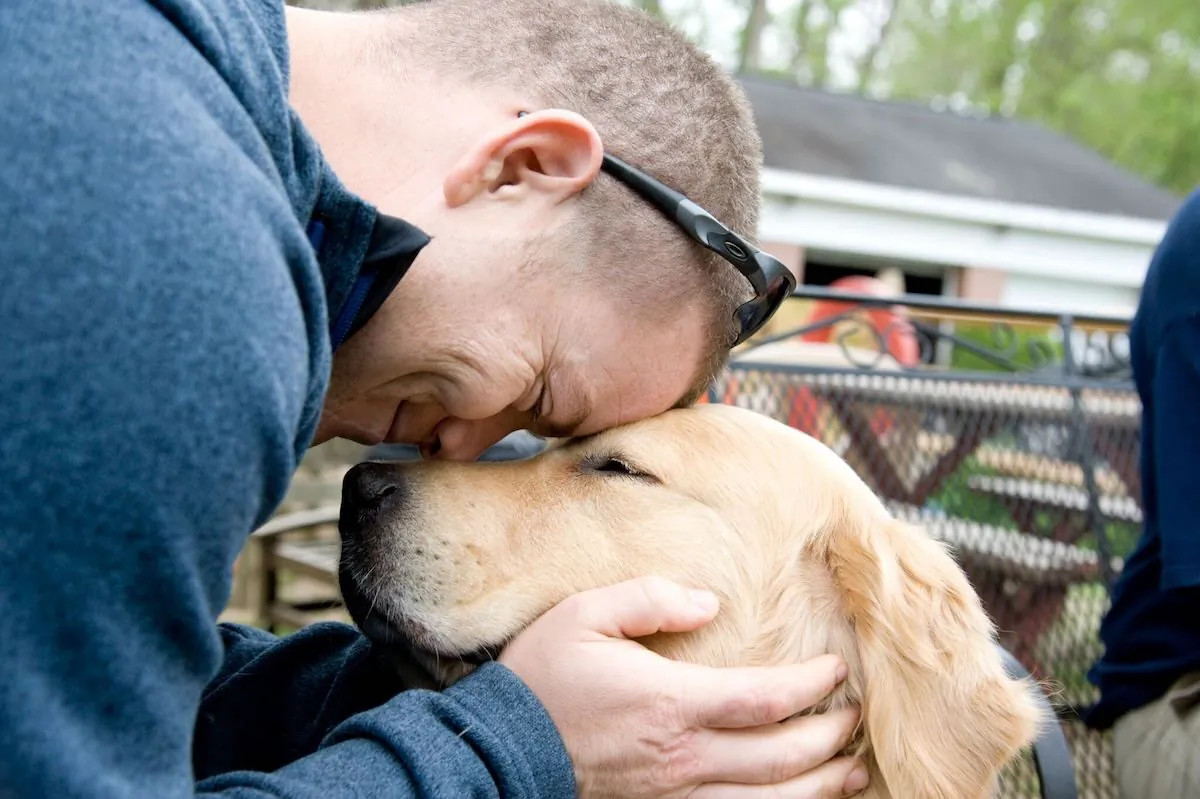 A veteran bonds with a service dog from Warrior Canine Connection. (Bonnie Grower)