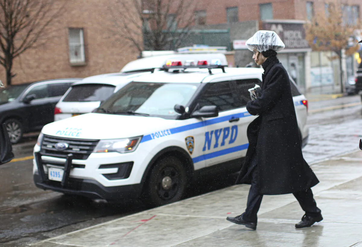 A NYPD car patrols in South Williamsburg Brooklyn on Dec. 30, 2019 in New York City, two days after an intruder wounded five people at a rabbi's house in Monsey, New York. (KENA BETANCUR/AFP via Getty Images)