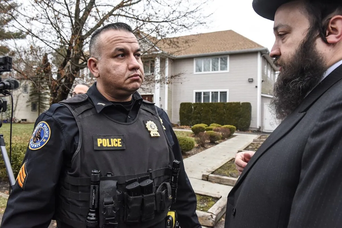 A member of the Ramapo police stands guard in front of the house of Rabbi Chaim Rottenberg in Monsey, New York on Dec. 29, 2019. Five people were injured in a knife attack during a Hanukkah party and a suspect, identified as Grafton E. Thomas, was later arrested in Harlem. (Stephanie Keith/Getty Images)