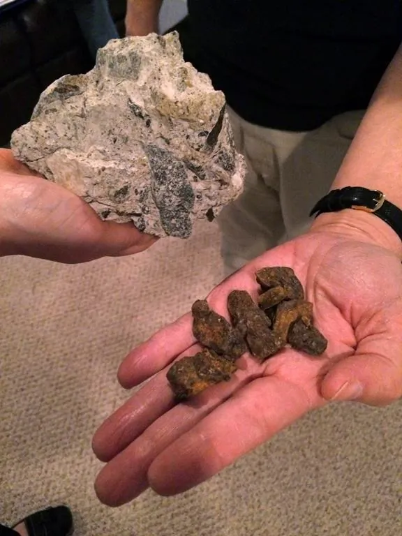 Nuggets of the rust-coloured mineral pyrrhotite (R) and a chunk of concrete containing the mineral that's been removed from a crumbling basement (L) in a file photo. (The Canadian Press/AP-Susan Haigh)