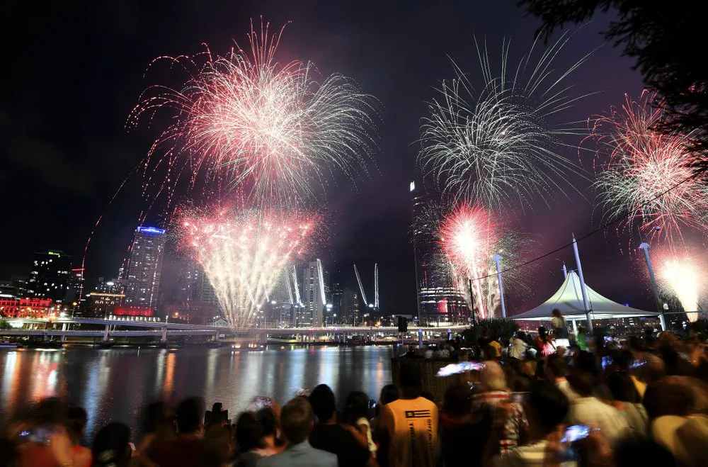 Crowds watch a fireworks display during New Year's Eve celebrations in Brisbane, Tuesday, Dec. 31, 2019. (Dan Peled/AAP Image via AP)
