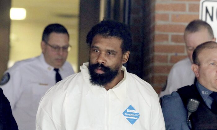 Grafton Thomas is led from Ramapo Town Hall in Ramapo, N.Y. following his arraignment on Dec. 29, 2019. (Seth Harrison/The Journal News via AP)
