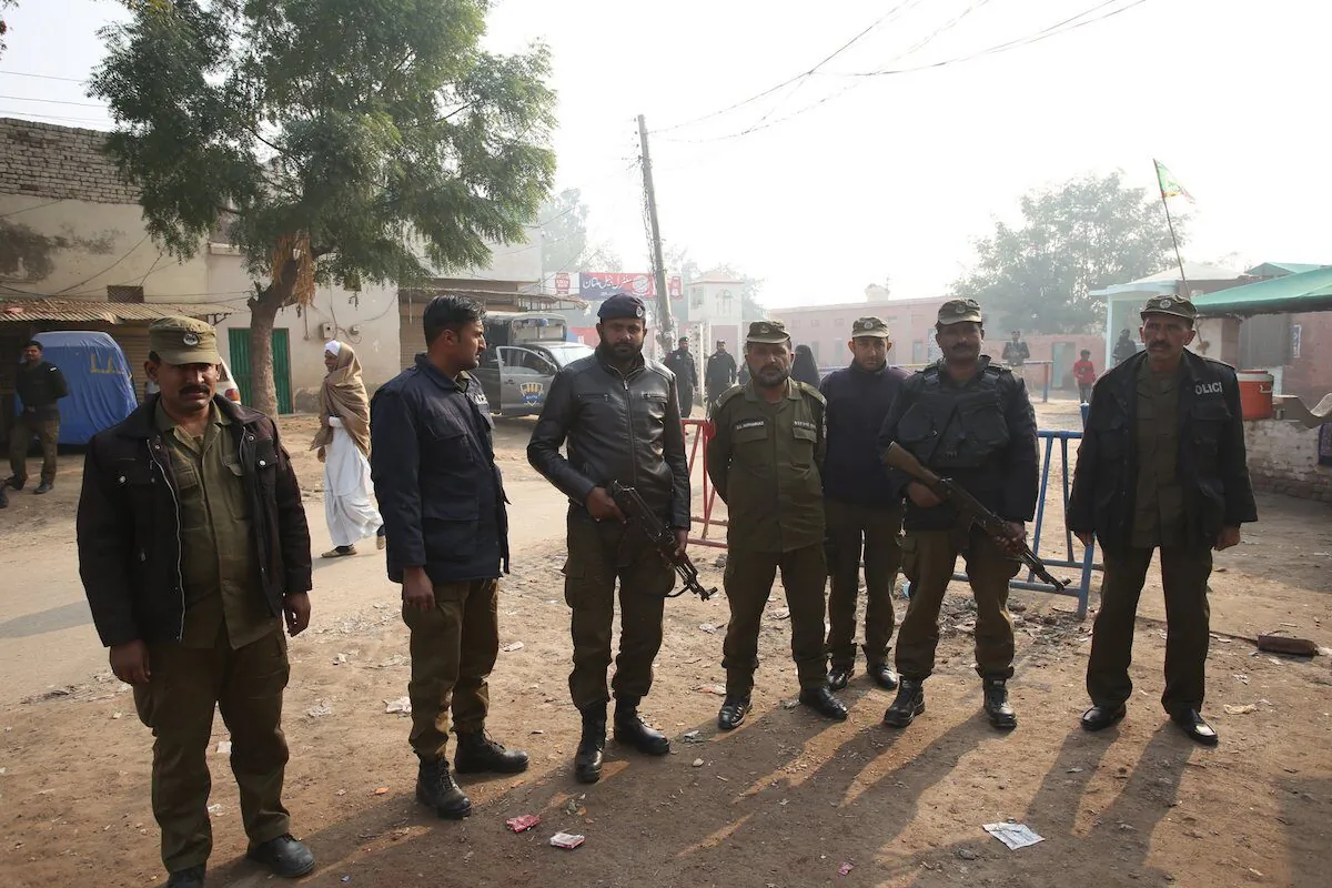 Pakistani police officers stand guard outside Multan jail after a court's decision for a professor facing blasphemy case, in Multan, Pakistan, on Dec. 21, 2019. (AP Photo/Asim Tanveer)

