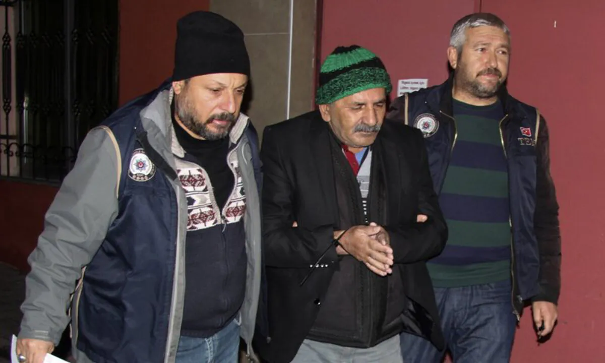 Security members detained a man in central Anatolian city of Kayseri, Turkey, early Dec. 30, 2019. (DHA via AP)