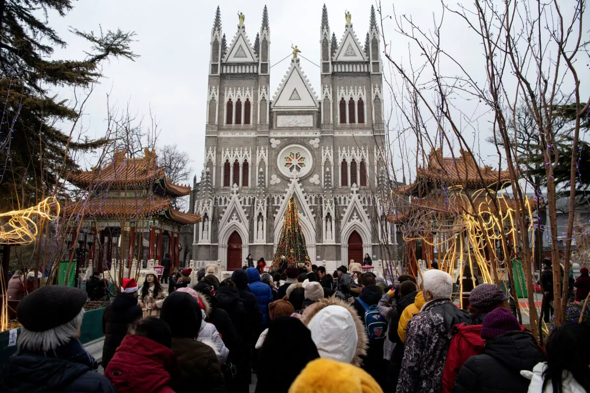 Worshippers wait outside the Xishiku Cathedral to attend a Christmas eve mass in Beijing on Dec. 24, 2019. (Noel Celsis/AFP via Getty Images)