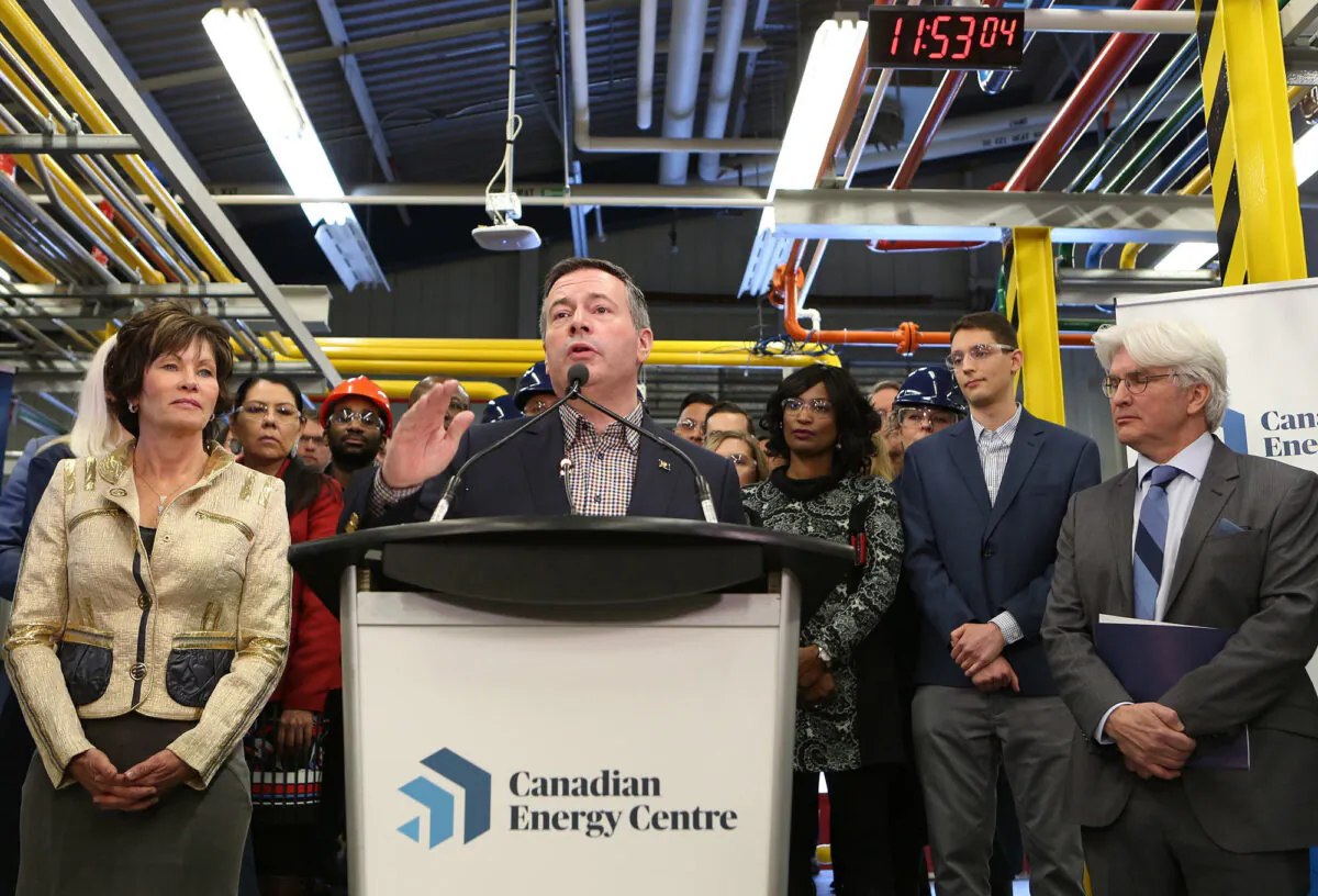 Alberta Premier Jason Kenney (C) announces the launch of the Canadian Energy Centre (CEC) as Energy Minister Sonya Savage and CEC managing director and CEO Tom Olsen look on at a press conference in Calgary on Dec. 11, 2019. (The Canadian Press/Greg Fulmes)