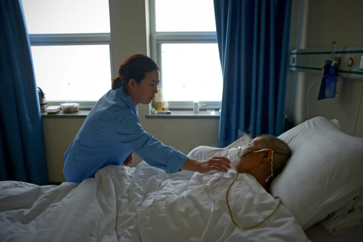 A man suffering from pneumonia receives treatment in a ward at Wang Fu Hospital in Beijing on December 9, 2015. (WANG ZHAO/AFP via Getty Images)