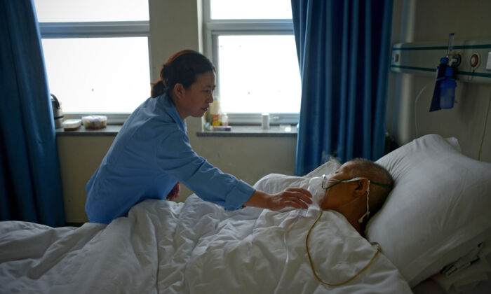 A man suffering from pneumonia receives treatment in a ward at Wang Fu Hospital in Beijing on December 9, 2015. (WANG ZHAO/AFP via Getty Images)