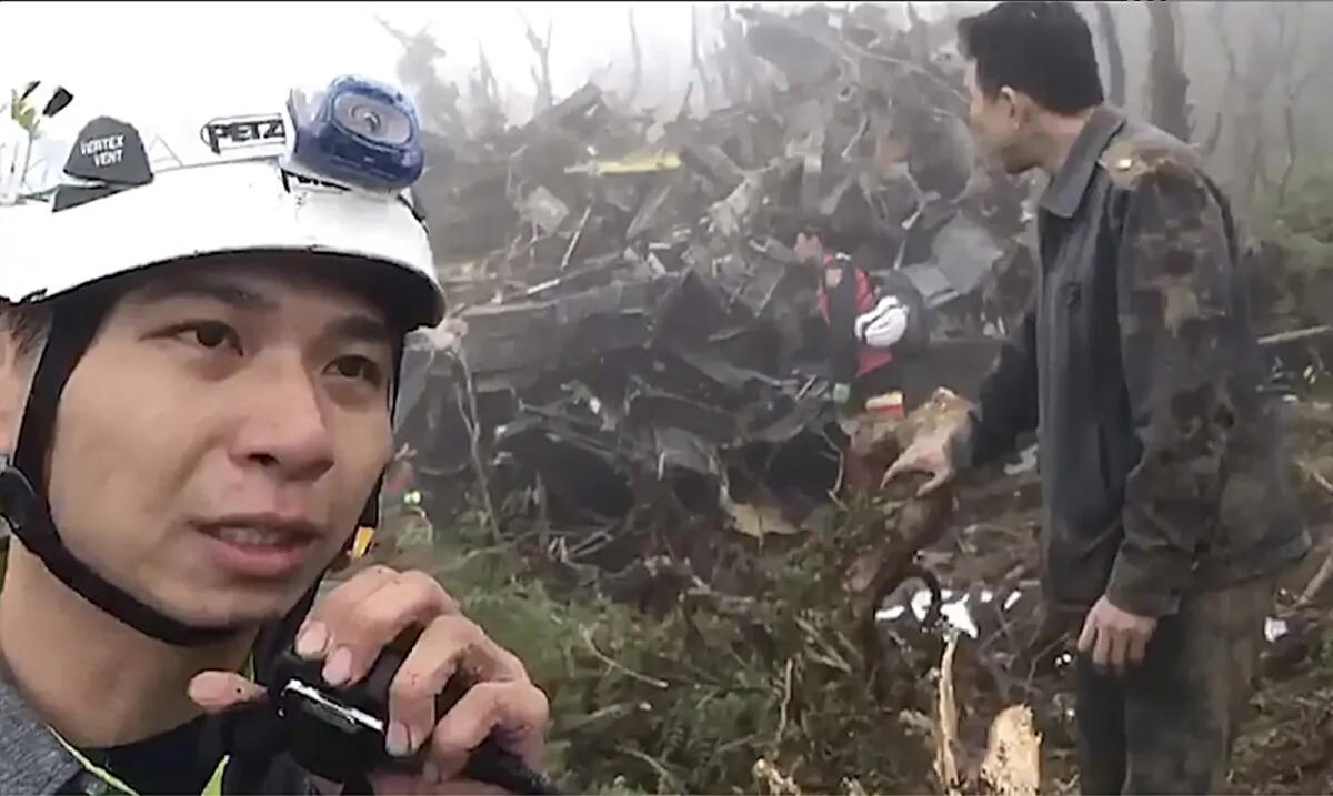 In this image made from video, emergency teams work at the crash site of a military helicopter in the mountains of Yilan, north eastern Taiwan on Jan. 2, 2020. (Yilan Fire Bureau via AP)